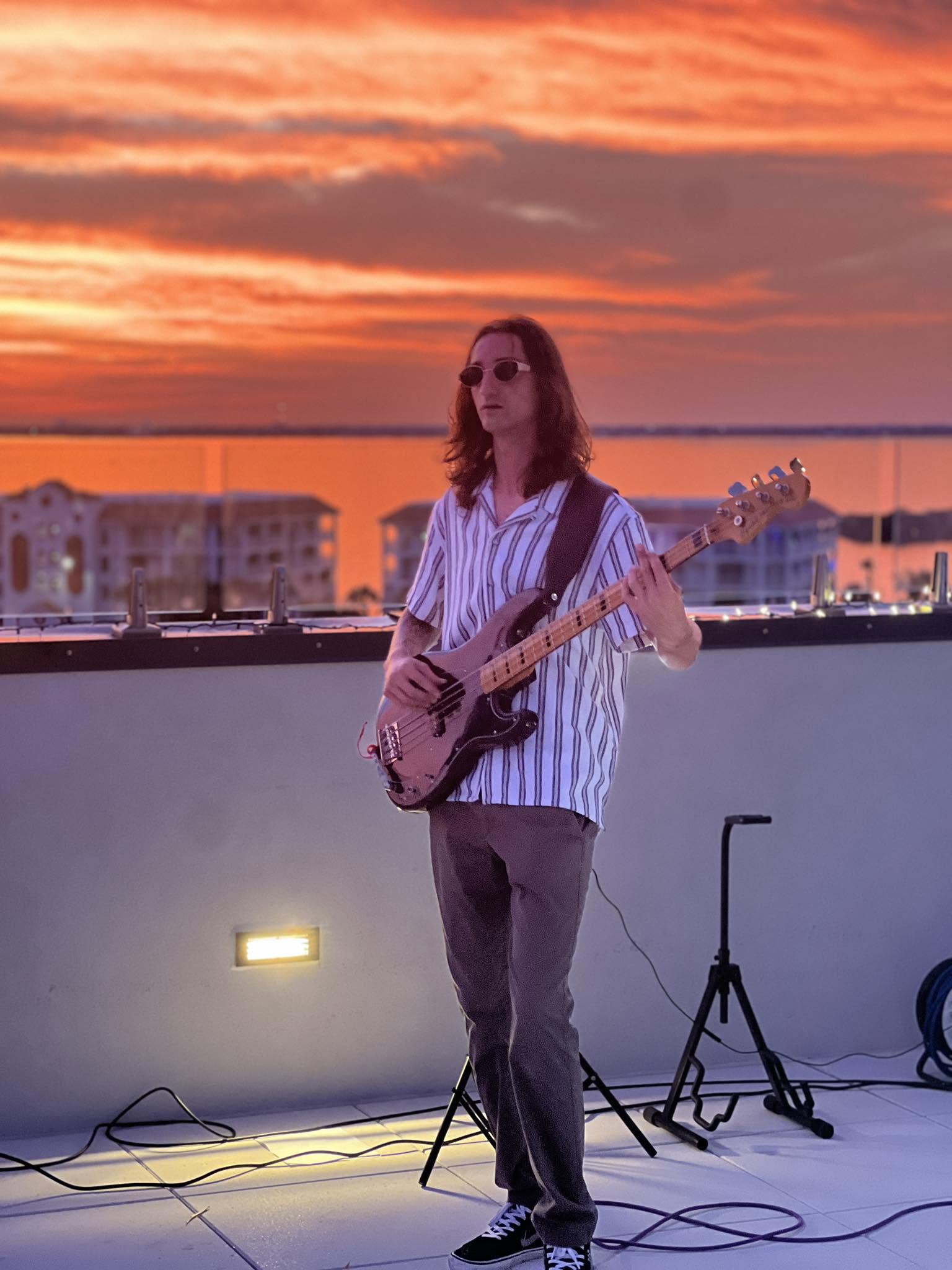 Nick on bass against Florida sunset
